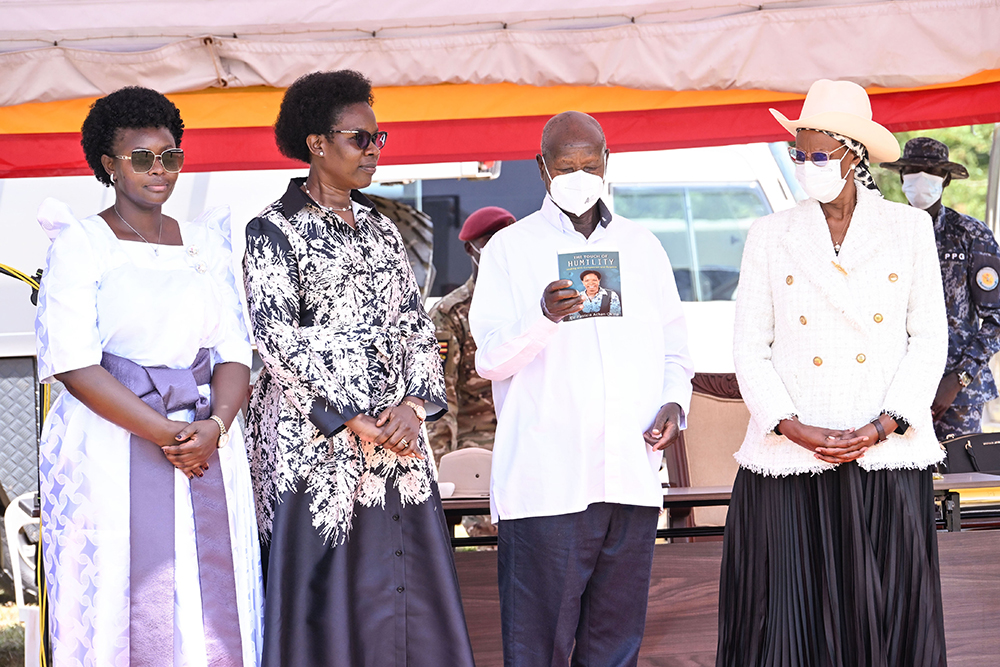 President Museveni launching Deputy IGG, Dr Patrocia Okiria's book (2nd L), as First Lady Janet Museveni (R) and Hon. Lillian Aber (L) look on during Archbishop Janani Luwum Day in Mucwuni, Kitgum on Monday.