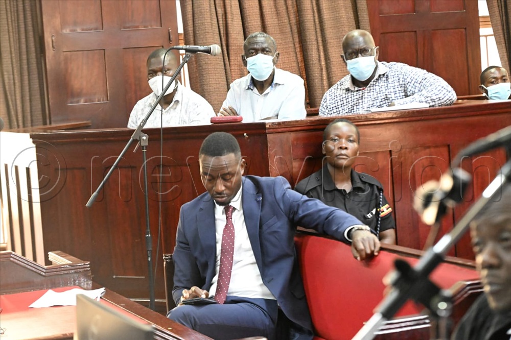 Dr. Kizza Besigye, Hajji Obeid Lutale, and UPDF Captain Denis Oola in the dock at high court in Kampala.