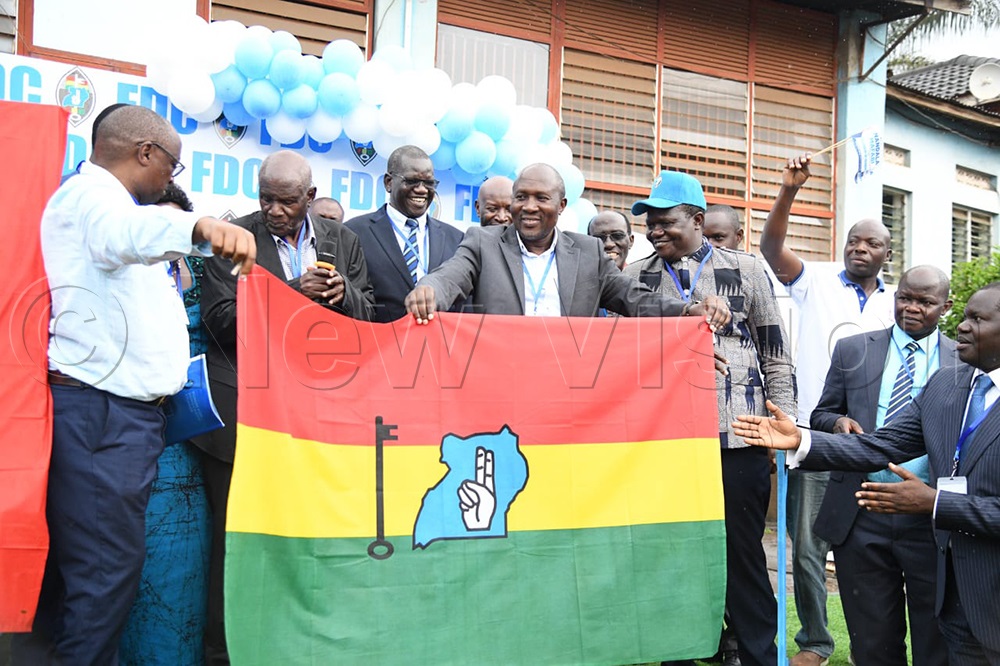 FDC party officials holding the party flag. (Credit: Maria Wamala)