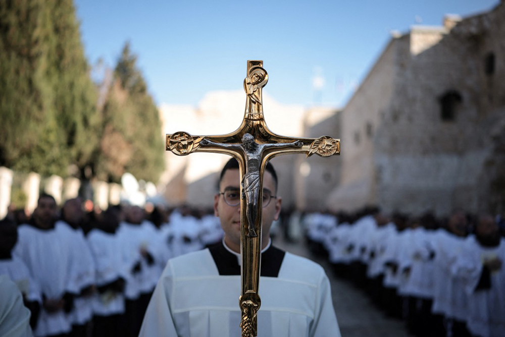 Members of the clergy take part in the yearly Christmas procession led by Latin Patriarch of Jerusalem outside the Church of the Nativity in the Israeli-occupied West Bank city of Bethlehem  on December 24, 2025. (AFP)