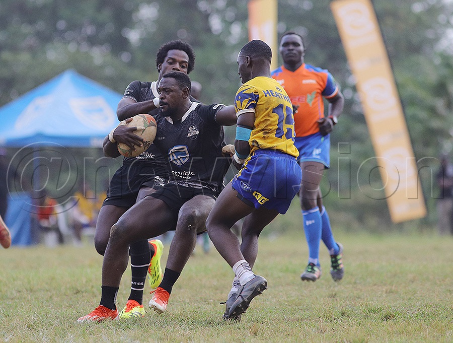 Heathens' Mathew Musasizi (in yellow) tackles Pirates' Alex Aturinda during the Rujumba 7s final. Pirates edged Heathens 26-24 at Kings Park Arena, Bweyogerere. PHOTO: Johnson Were
