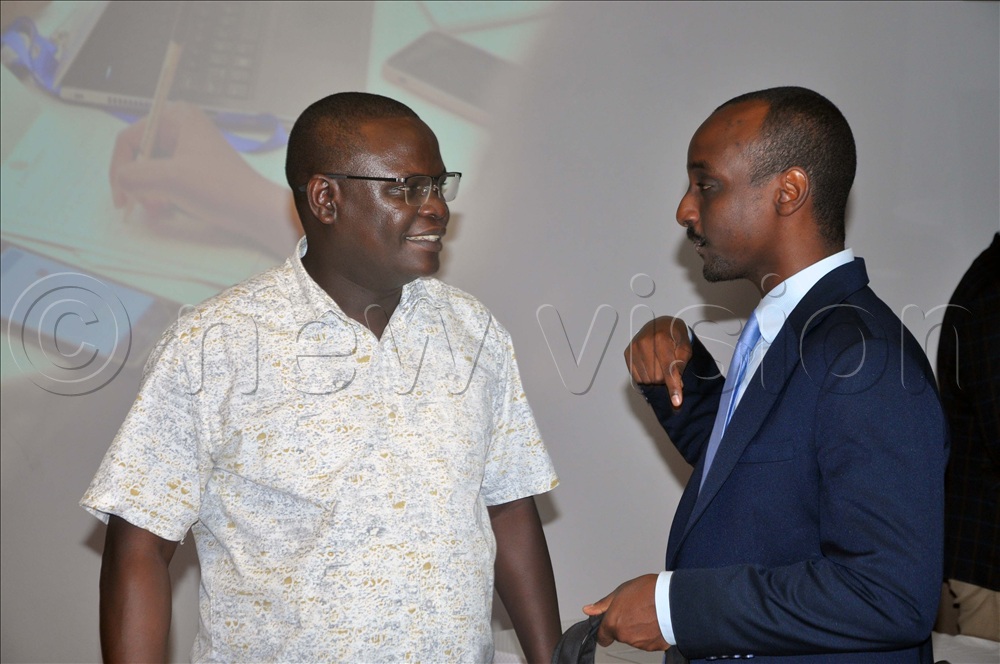 Kedi (Right) and Kutesa (Left) discussing during a meeting on mining at the Kabira Country Club, Kampala. 