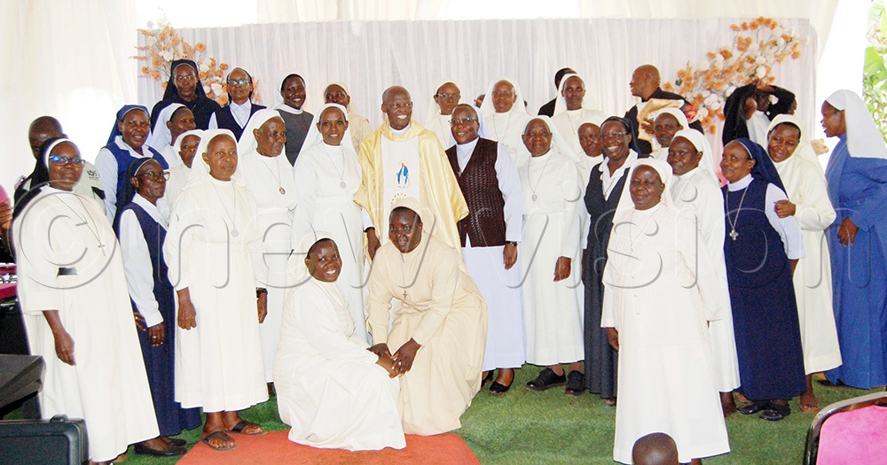 Fr. Dr Expedito Kakuba Kapia (wearing a yellowish chasuble) shares a photo-moment with the Catholic nuns who graced his golden jubilee function (Photo by Mathias Mazinga)