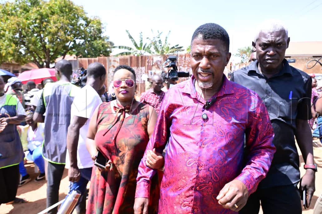 Balimwezo hand in hand with his wife, Racheal, who was dressed in a red floral dress as they arrived to cast their vote. (Credit: Mpalanyi Ssentongo)