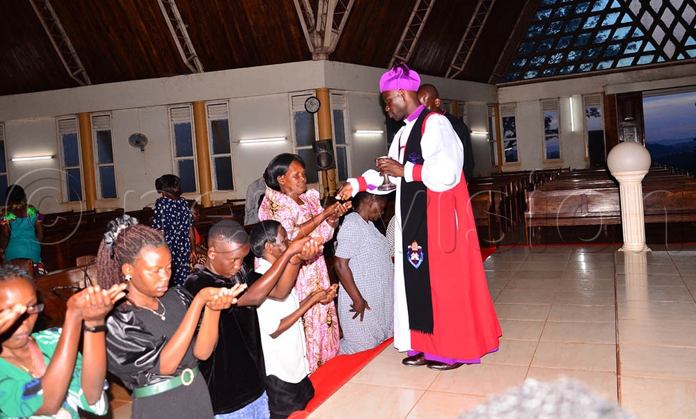 Anglicans receive Holy Communion hosted by the Rt. Rev. Prof. Grace Lubaale as he signified Jesus' Last Supper at the Cathedral on Holy Thursday. (Credit: Jackie Nambogga)