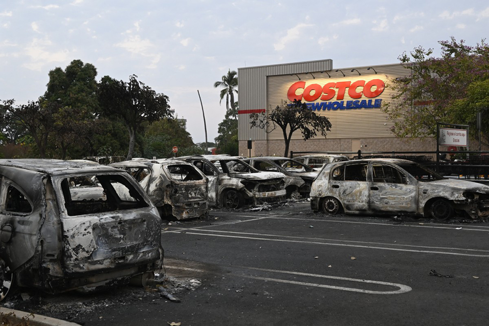 Burned cars are seen in the parking lot of a Costco retail store in Puerto Vallarta, Jalisco state, Mexico on February 23, 2026. Mexico has deployed 10,000 troops to quell clashes sparked by the killing of the country's most wanted drug lord, which have left dozens dead, officials said on February 23. (Credit: AFP)
