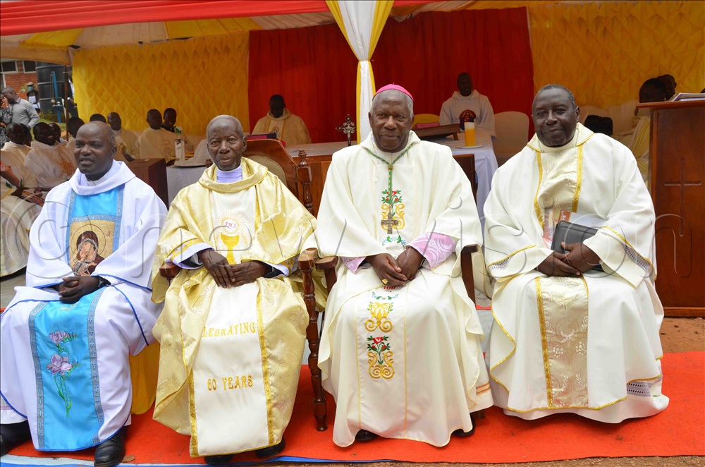 Fr Dr James Kabuye (seated second-left) poses for a photo with Bishop Joseph Antony Zziwa (wearing a skull-cap), Fr. Ben Mayindwe (left), and Fr. Charles Lugenda (right) during his priestly diamond jubilee celebration at Kiyinda-Mityana Catechetical Centre in 2022.