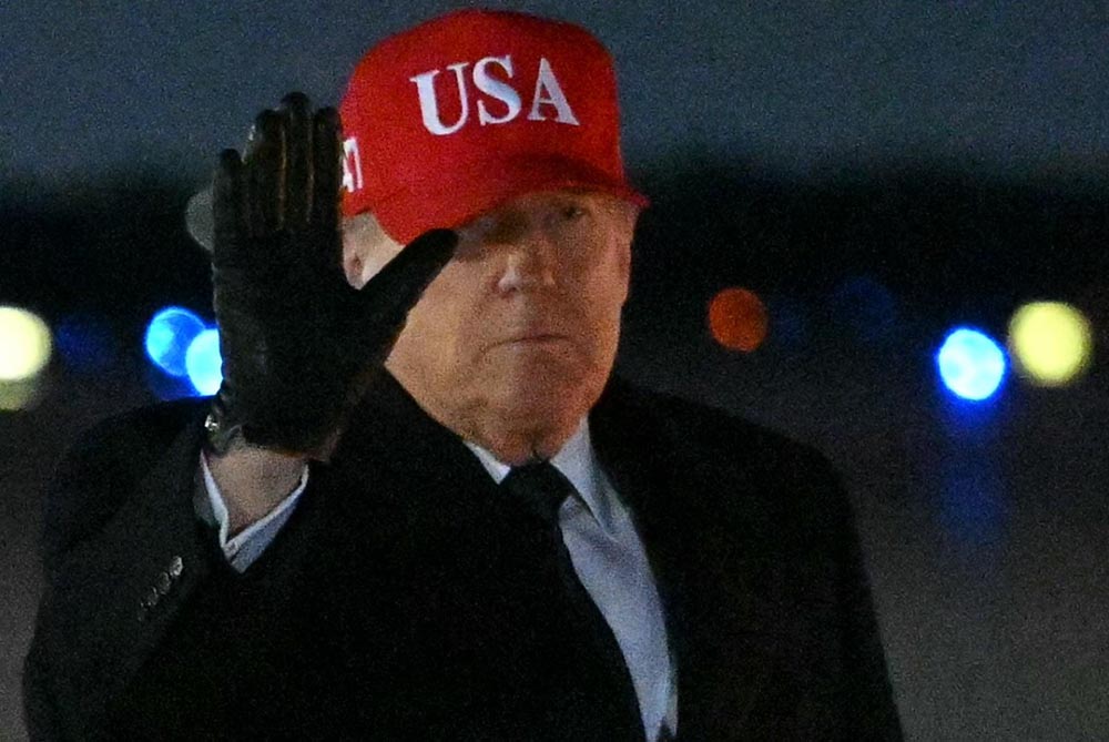 US President Donald Trump gestures after stepping off Air Force One upon arrival at Joint Base Andrews on March 1, 2026, on his way back to Washington, DC after spending the weekend at his Mar-a-Lago resort. (Credit: AFP)