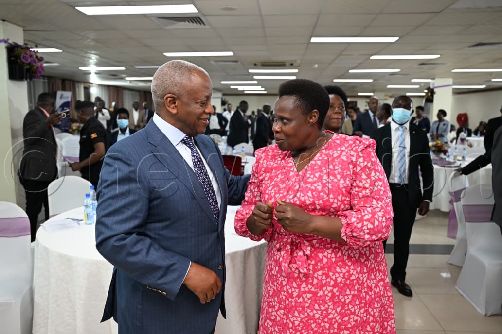 Former Prime Minister Amama Mbabazi shares with Vice President Jessica Alupo during the book launch at Hotel Africana. (Photo by Miriam Najjingo)