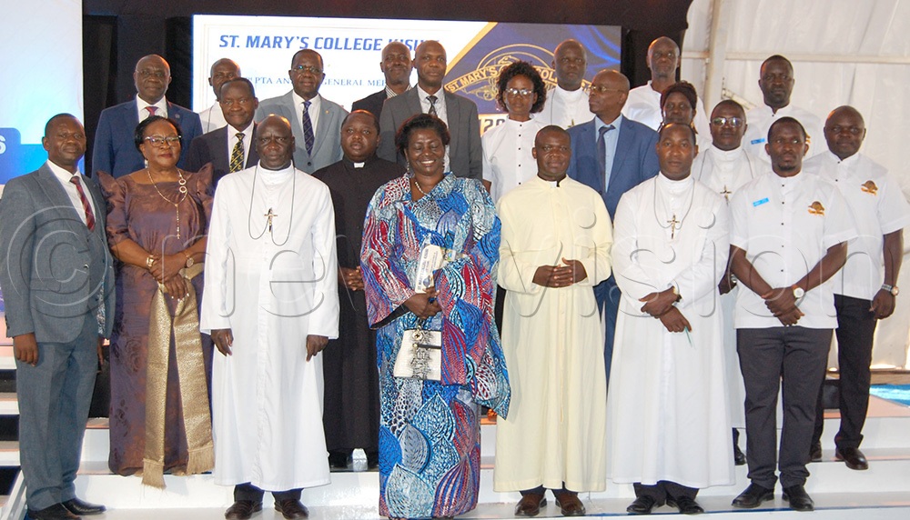 The Provincial Superior of the Brothers of Christian Instruction, Bro. Casio Aizire (third-left, front row) shares a photo moment with members of the executive of the Parents and Teachers Association of St. Mary's College Kisubi (SMACK) after the general meeting at the school on Entebbe Road, Wakiso District on Sunday, July 26, 2026. (Photo by Mathias Mazinga)