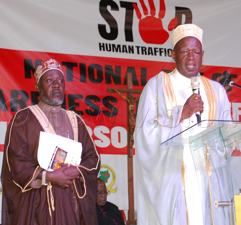 Sheikh Sserwadda Hamid (from the Uganda Muslim Supreme Council, behind the microphone) and his colleague praying for the nation. (Credit: Mathias Mazinga)