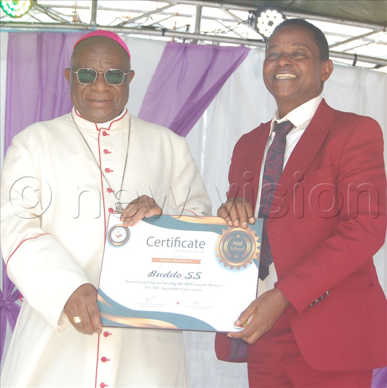 Archbishop Paul Ssemogerere presents a special certificate of appreciation to the headteacher of Buddo SS, Lawrence Muwonge, who hosted this year's Pro-life convention.