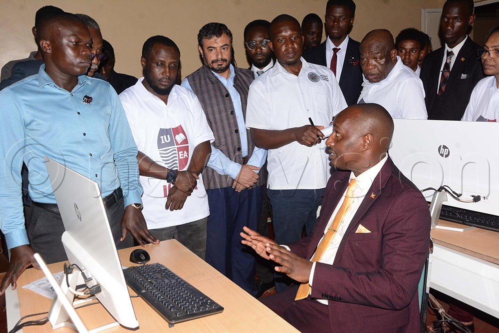 (L-R) Henry Sentalo, Lecturer Petroleum Engineering and Prof. Shema Abdulsalam Dean, Faculty of Engineering, explaining to Jonard Asiimwe, the Minister for Science, Technology and Innovation and Prof. Emeka Akaezuwa Vice Chancellor of International University of East Africa (IUEA)about engineering. (Photo by Mary Kansiime)