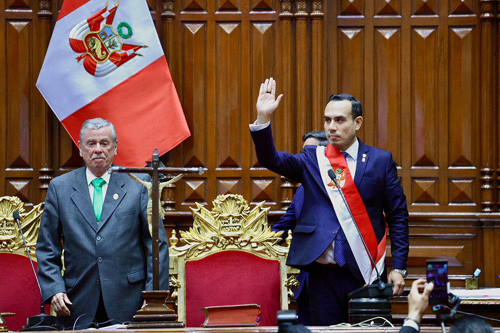 This handout from the Congress of the Republic of Peru taken and released on October 10, 2025, shows Peru's new interim president Jose Jeri Ore (R) gesturing before being sworn in during a ceremony at the National Congress in Lima, after lawmakers impeached former president Dina Boluarte.