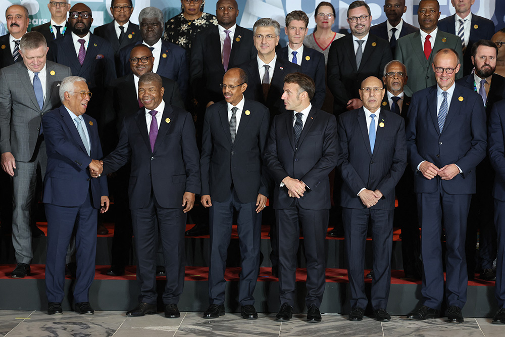 (From L) European Council President Antonio Costa, Angola's President Joao Lourenco, African Union Commission Chairperson Mahamoud Ali Youssouf, France's President Emmanuel Macron, Mauritania's President Mohamed Ould Ghazouani, and Germany's Chancellor Friedrich Merz pose for a family photo at the end of the first day of the Africa Union (AU) - European Union (EU) Summit the Salao Protocolar in Luanda on November 24, 2025. (Photo by Ludovic MARIN / AFP)
