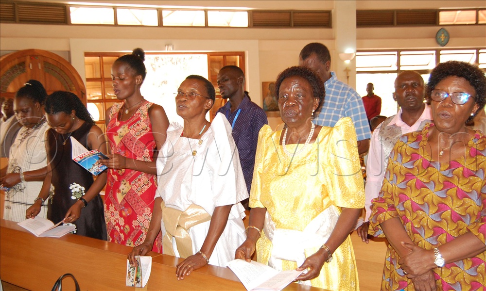 National Council for Higher Education Boss Mary Okwakol (right) with other Christians during mass.