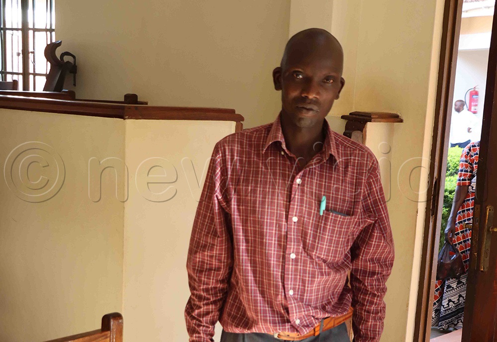 Andrew Opio Ogule poses for a photo before he left the court for his home, after he was set free of murder case. (Photo by Hudson Apunyo)
