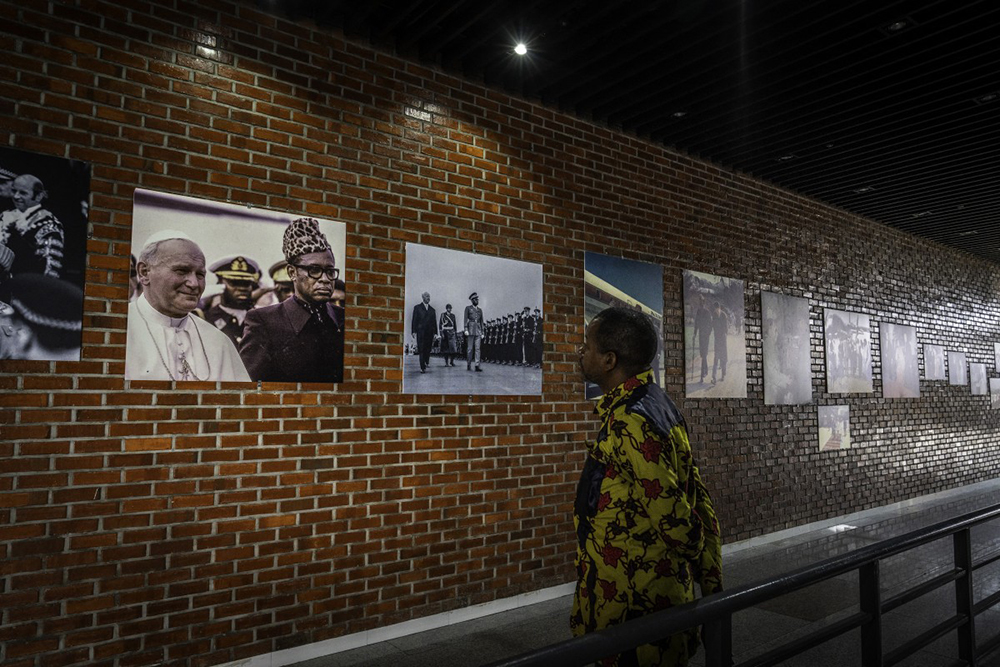 A visitor looks at photos from the exhibition ‘Mobutu, a life, a destiny’ at the National Museum in Kinshasa, on October 17, 2025. 