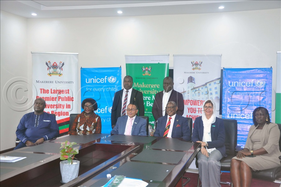 Prof. Nawangwe (Third Right) and Dr. Nandy (Third Left) during the signing of an agreement aimed at improving the lives and rights of children in Uganda. The two leaders were flanked by senior officials from both organisations. The function took place at Makerere University. (Credit: John Odyek)
