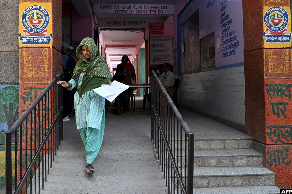 A woman leaves after submitting documents to register for the Draft Electoral Roll 2026 in New Delhi on October 18, 2026. (AFP)