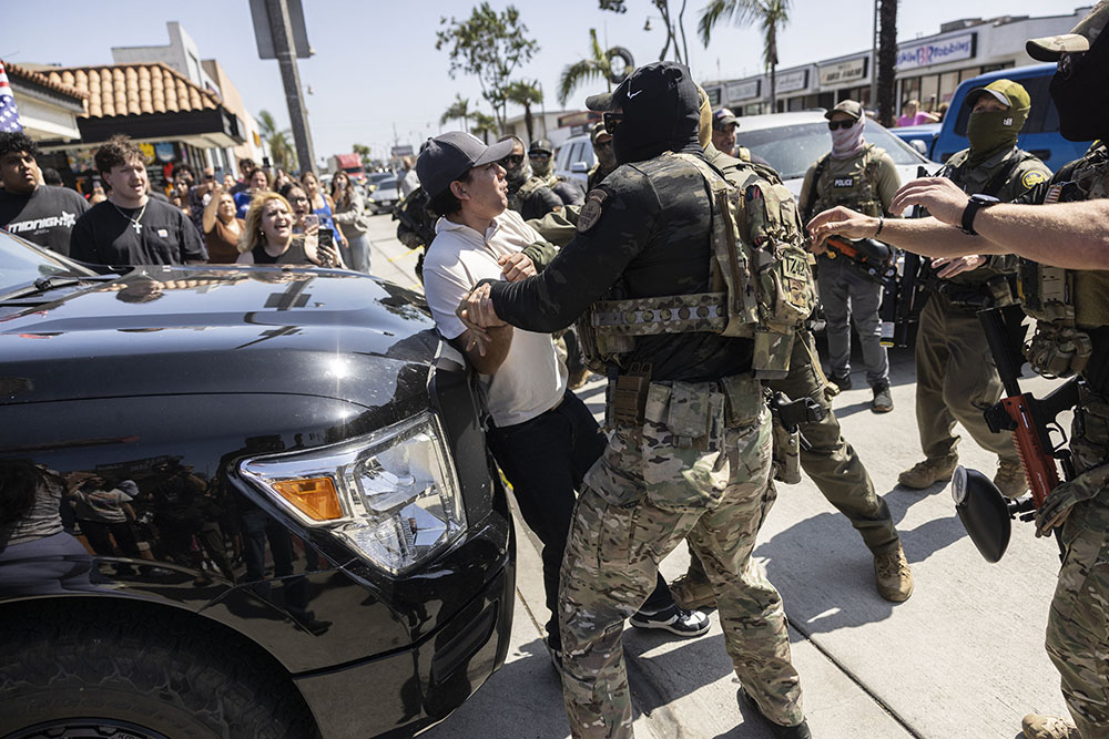 A man is detained as clashes break out after US Customs and Border Protection (CBP) officers attempted to raid a store in Bell, just south of Los Angeles, California, on June 20, 2025. (File Photo)