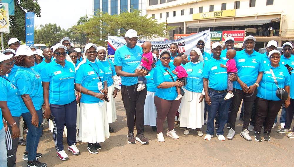 The Principal walkers and stakeholders of Nsambya Babies Home who included the Central Bank Governor Dr. Michael Atingi-Ego (sixth-left), and Hon. Justine Kasule Lumumba (on Dr. Etingi-Ego's immediate left) share a group photo-moment during the centre's fundraising charity walk at the Uganda Railway Grounds on Jinja Road in Kampala on Saturday, July 25, 2026. (Photo by Mathias Mazinga)