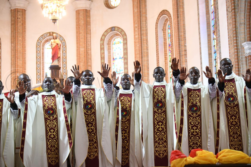 The newly ordained priests bless the congregation. (Credit: Maria Wamala)