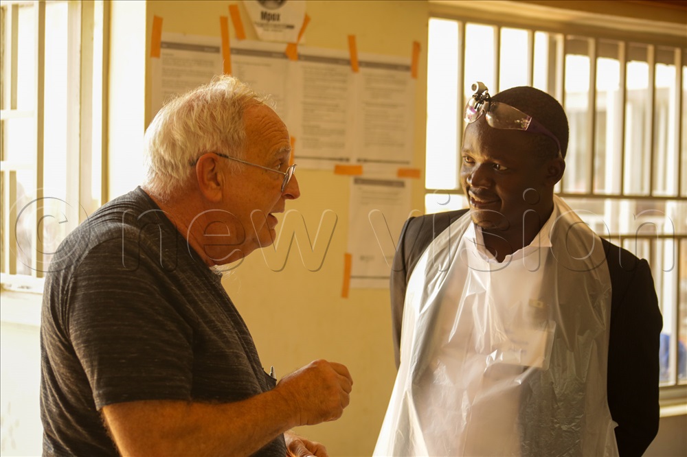 Dr. Wyne Lose who led the American group of doctors to Serere sharing with a Ugandan dentist during the Serere Dental Camp.