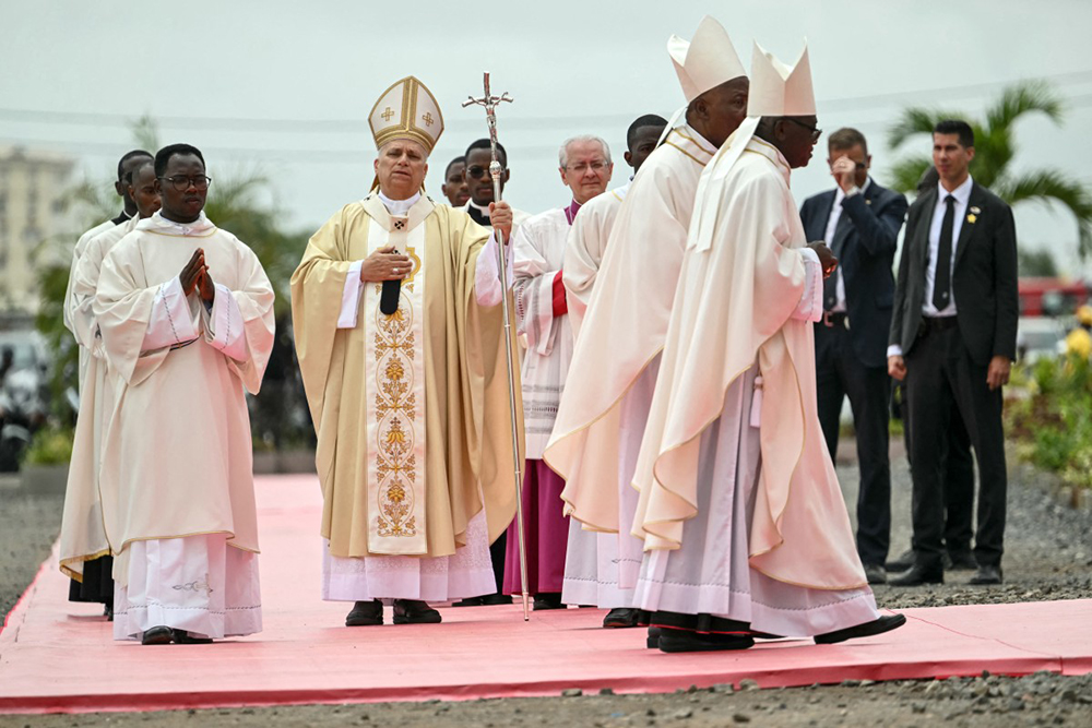 Pope Leo XIV (C) arrives to lead a Holy Mass in Kilamba on the seventh day of an 11-day apostolic journey to Africa, on April 19, 2026. 