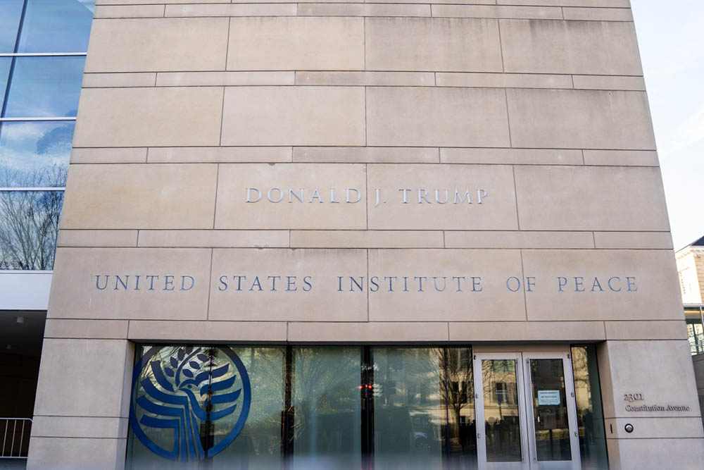 The name of US President Donald Trump is displayed on the outside of the United States Peace Institute after it was recently added, as a signing agreement ceremony is taking place between Rwanda and the Democratic Republic of the Congo in Washington, DC, on December 4, 2025. (Credit: AFP)
