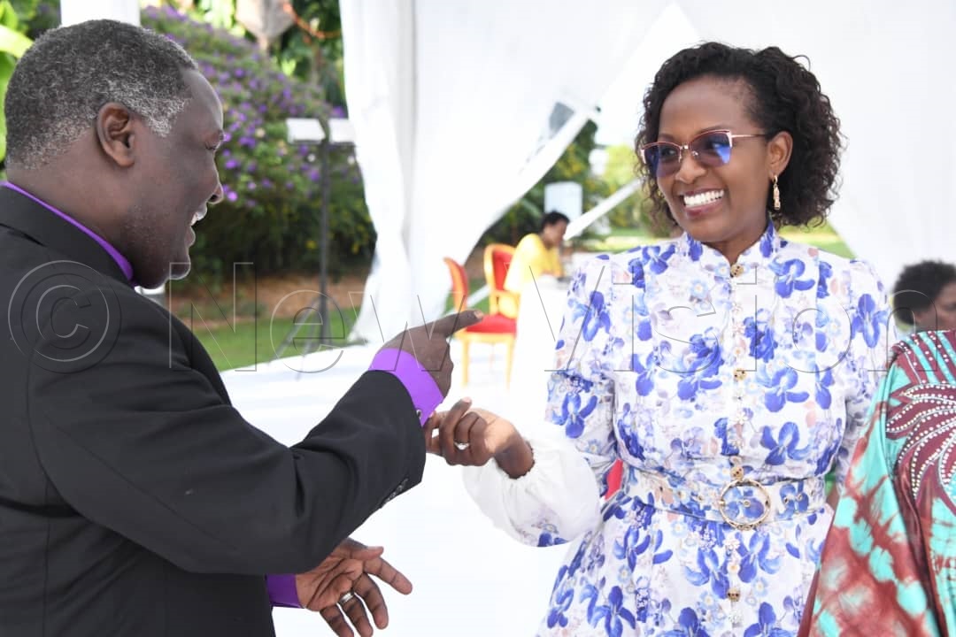 Pastor Joshua Lwere sharing a light moment with Lona Magara.