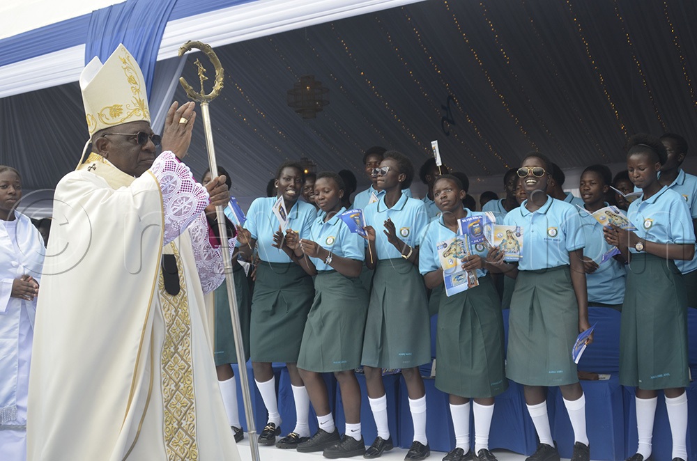 The Archbishop of Kampala, Paul Ssemogerere, blessing students before the mass marking 25 years of academic and spiritual excellence on Saturday, July 4, 2026. (Photo by Juliet Anna Lukwago)