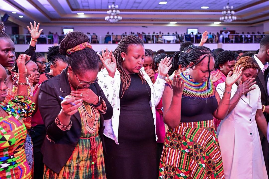 Women in a moment of prayer.