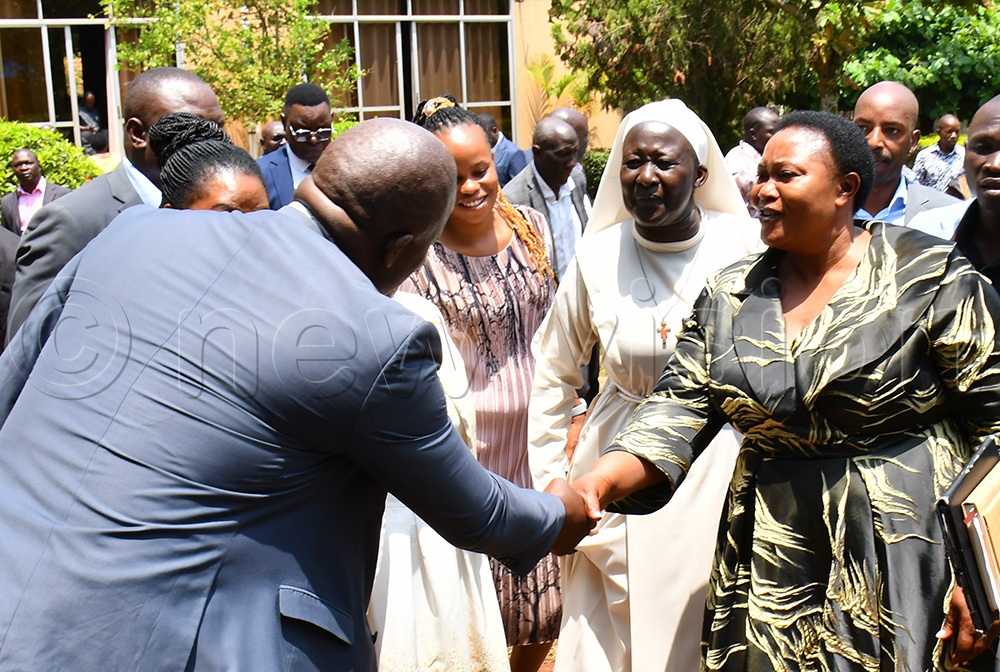 The Namayingo RDC Emmy Mitala (left) greeting the Minister for Presidency, Milly Babirye Babalanda (right), as Sister Grace Akiror (2nd right) looks on after closing the RDC's workshop at Source of the Nile Hotel in Jinja City on August 19th. (Photo by Donald Kiirya)