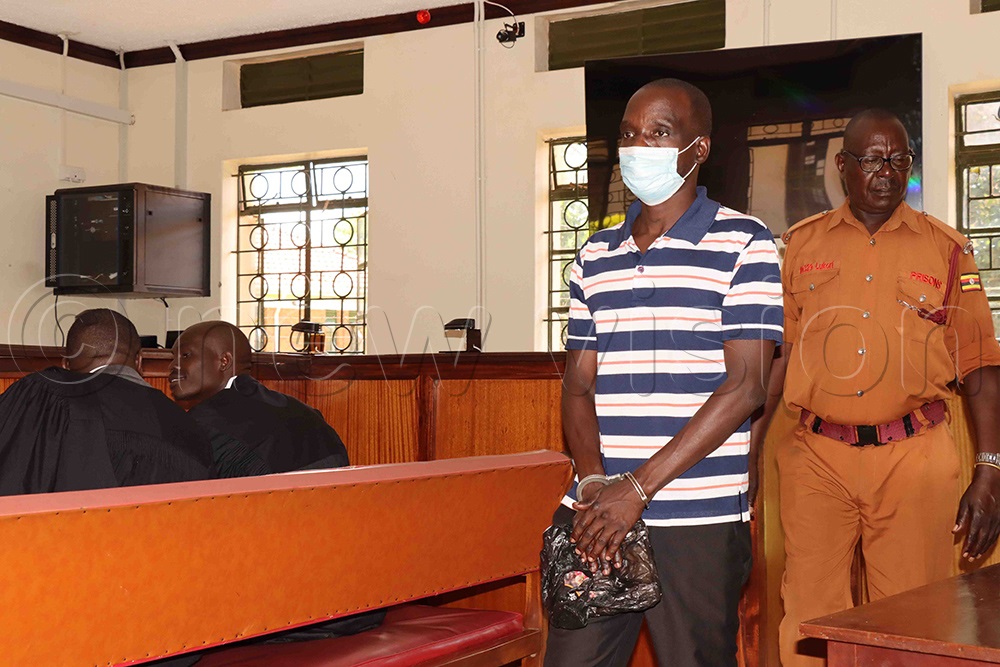 Kenneth Opio being led to cell after, Assessors advised court to convict him on both counts. (Photo by Hudson Apunyo)