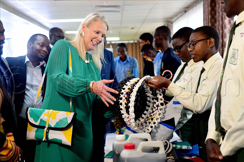 The British High Commissioner to Uganda Lisa Chesney looks at a basket made out of recycled plastic bottle tops and recycled polythene bags exhibited by students from St. Peters Senior Secondary School Nsambya. This was during her tour around a students&rsquo; exhibition themed sustainable waste management sponsored by the British High Commission through the Chevening Alumni Association of Uganda at Hotel Africana in Kampala on April 9, 2026.  