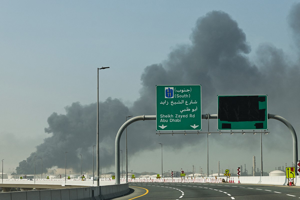 A plume of smoke rises from the port of Jebel Ali following a reported Iranian strike in Dubai on March 1, 2026. (AFP)