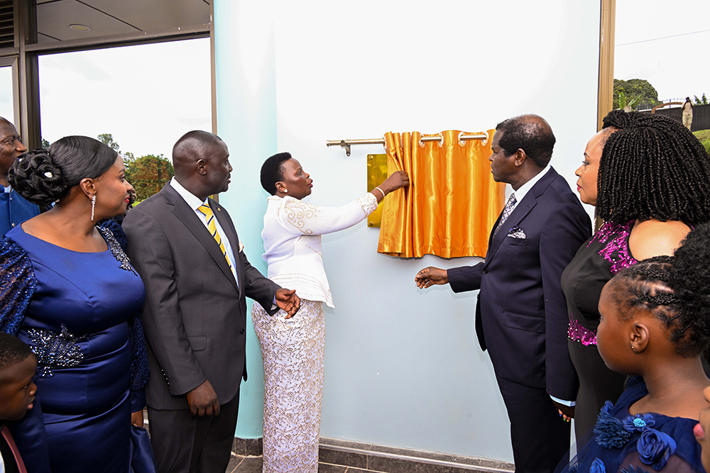 Hon. Beatrice Akello (C), State Minister for Economic Monitoring cuts the tape as she commissions Life Restoration Ministries Church auditorium at Bujuko on Saturday, April 25, 2026, as host Pastor Kenneth Kato (L) and Pastor Robert Kayanja look on. (PPU)