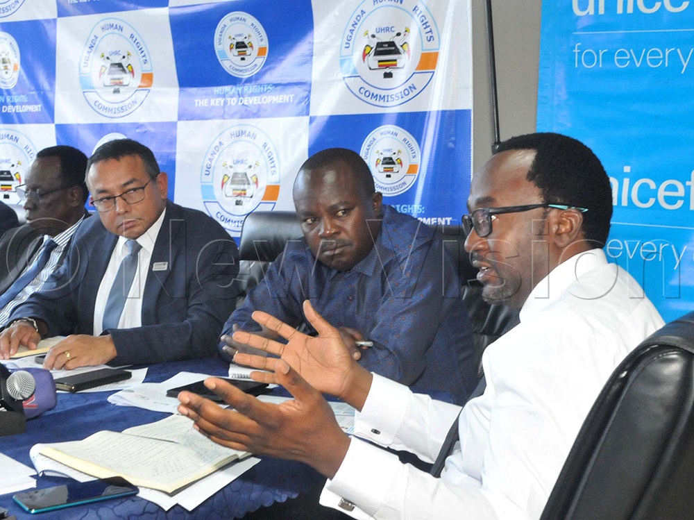 Dr Robin Nandy (Left), the UNICEF Representative, looks on with Simeo Nsubuga, a commissioner, as Crispin Kaheru, a commissioner of the Uganda Human Rights Commission, speaks during a press conference to promote and safeguard the rights and freedoms of children during electoral processes on Dec 8, 2025. (Credit: Nicholas Oneal)