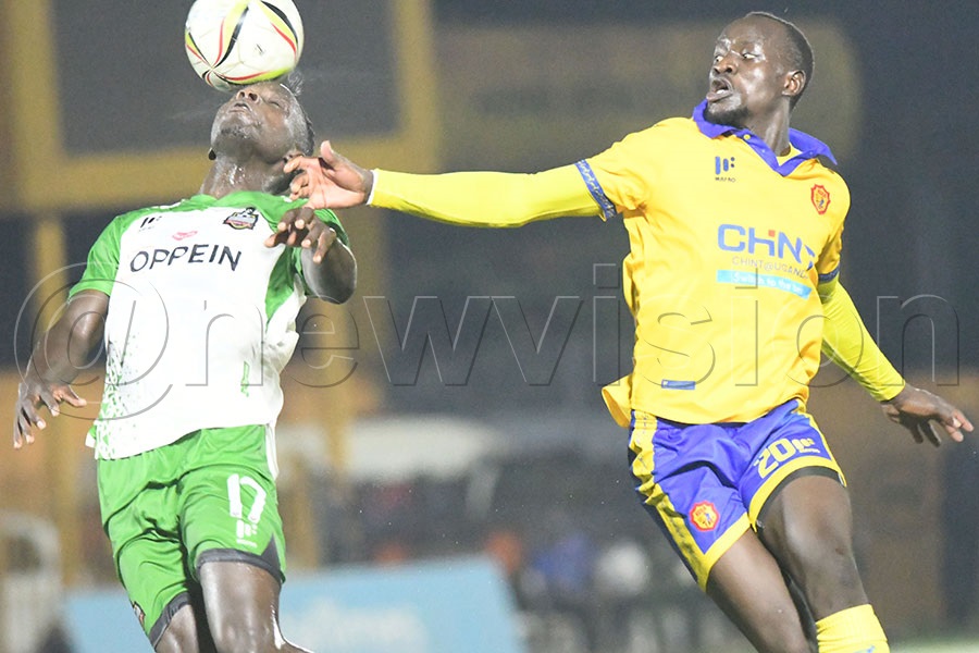 NEC FC's Odongo (left) and KCCA's Emmanuel Anyama contest for the ball during a UPL match at the Phillip Omondi Stadium, December 12, 2025. KCCA WON 2-1. Photo by Michael Nsubuga