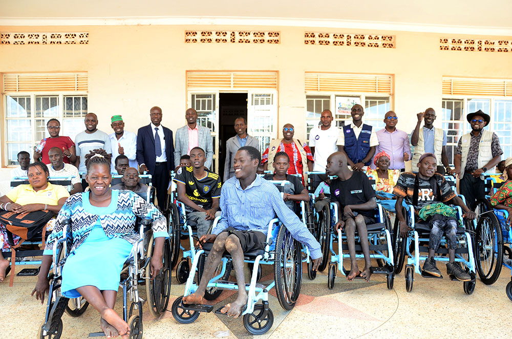  Some of the beneficiaries of the donated wheelchairs with officials of Luuka district, Amref Health Africa, Medical Research Council and Hope Health Africa. This was during the official handover of the wheelchairs at the district headquarters on May 7, 2026. (Credit: Lawrence Mulondo)
