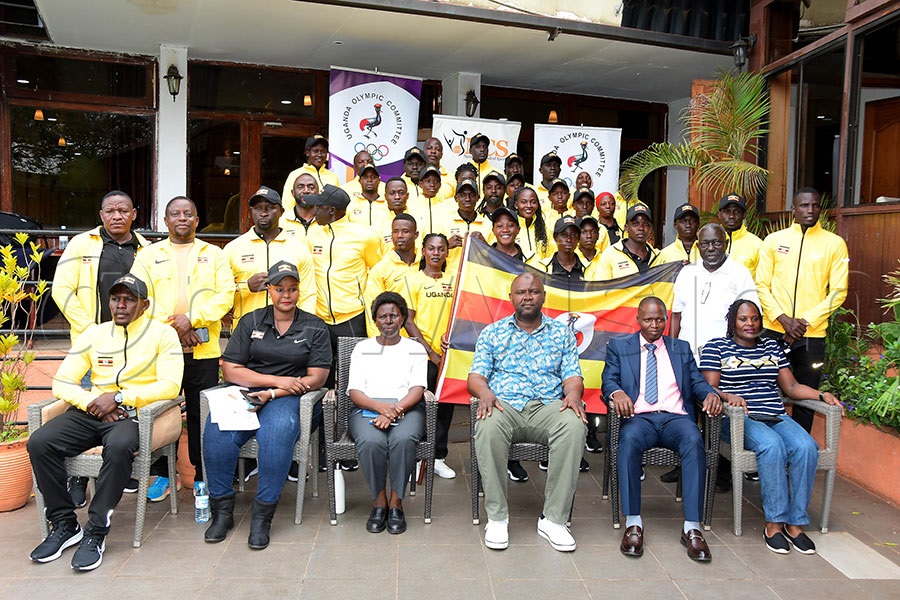 NCS and UOC officals (seated) pose for a family photo with the athletes during the flag off ceremony PHOTO: Silvano Kibuuka