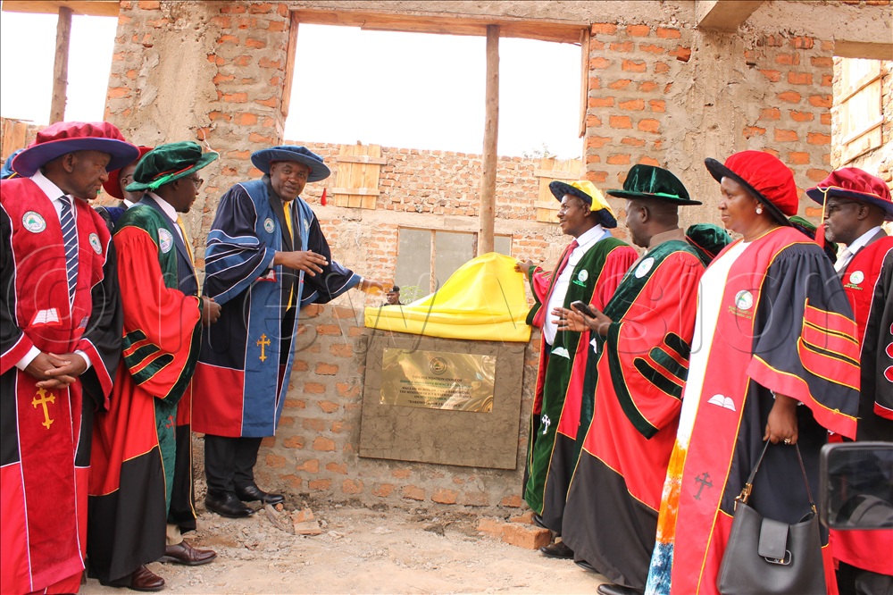Dr Chris Baryomunsi, minister for ICT and National Guidance accompanied by the top leadership of Ibanda University laying a foundation stone on the Science Laboratory block which is under construction. This was during the 9th graduation ceremony of the university.