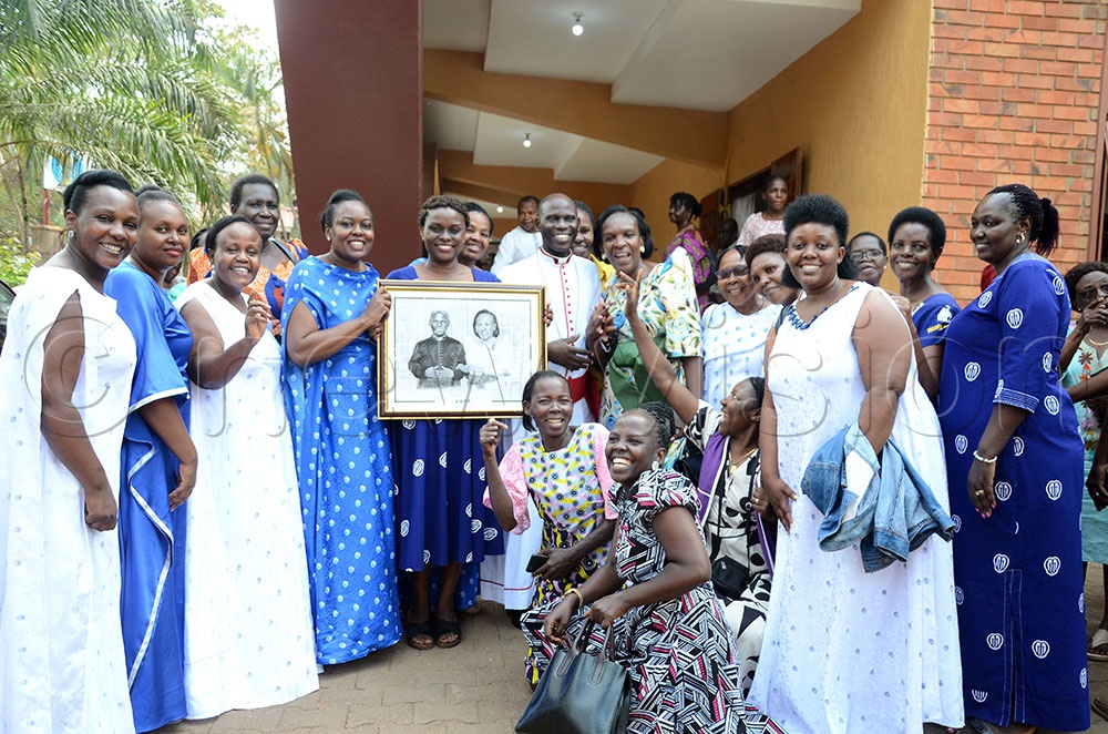 Rev. Canon Prof. Grace Lubaale, the fourth Bishop-elect of Busoga Diocese and his wife Clare Louise Atuheirwe posing for a picture with the members of the Mothers Union of Church of the Resurrection Bugolobi Kampala. (Photo by Lawrence Mulondo)