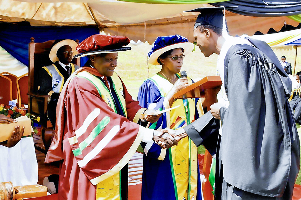 Professor George Wilson Kanyeihamba (left) congratulating a graduate during the university's graduation ceremony. (Courtesy)