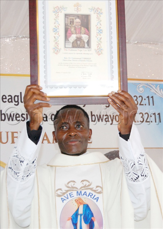 Fr. Emmanuel Tamale exposes the parchment of the Apostolic Blessing the Pope Leo XIV sent him.