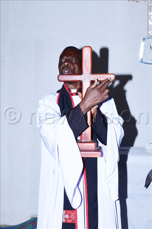 Archdeacon Pascal Odele preaching as he held a cross.