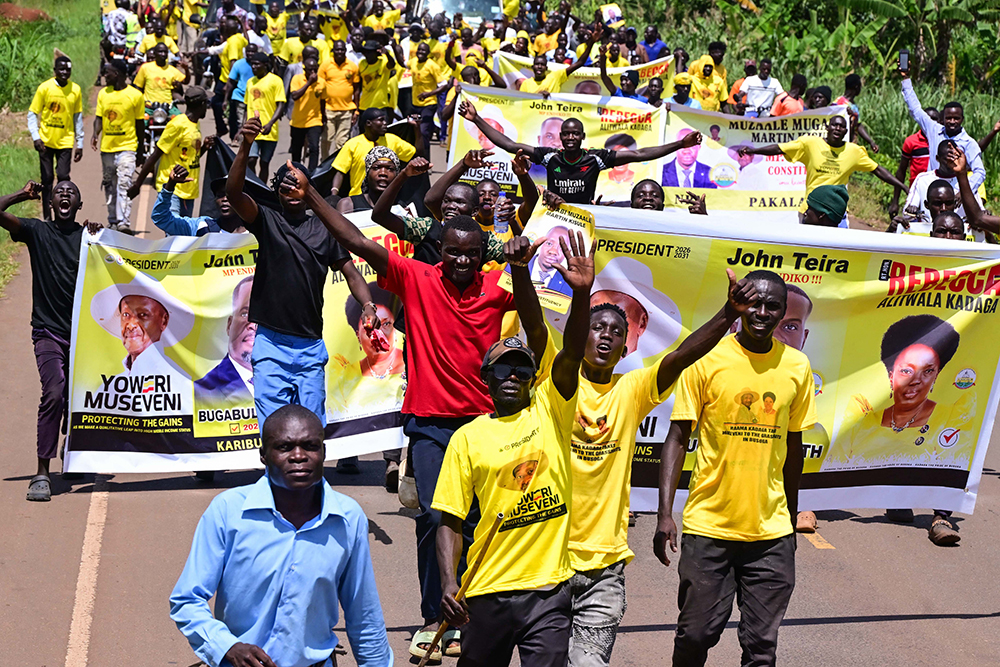 NRM supporters in Kamuli express their party support as they arrive for a campaign rally on Thursday. 