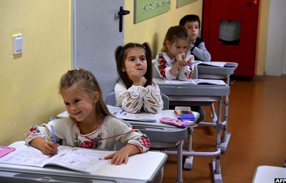 Schoolchildren attend a class in a shelter in the basement of UMKA Primary School during an air raid alert in the suburbs of Kyiv. (AFP)