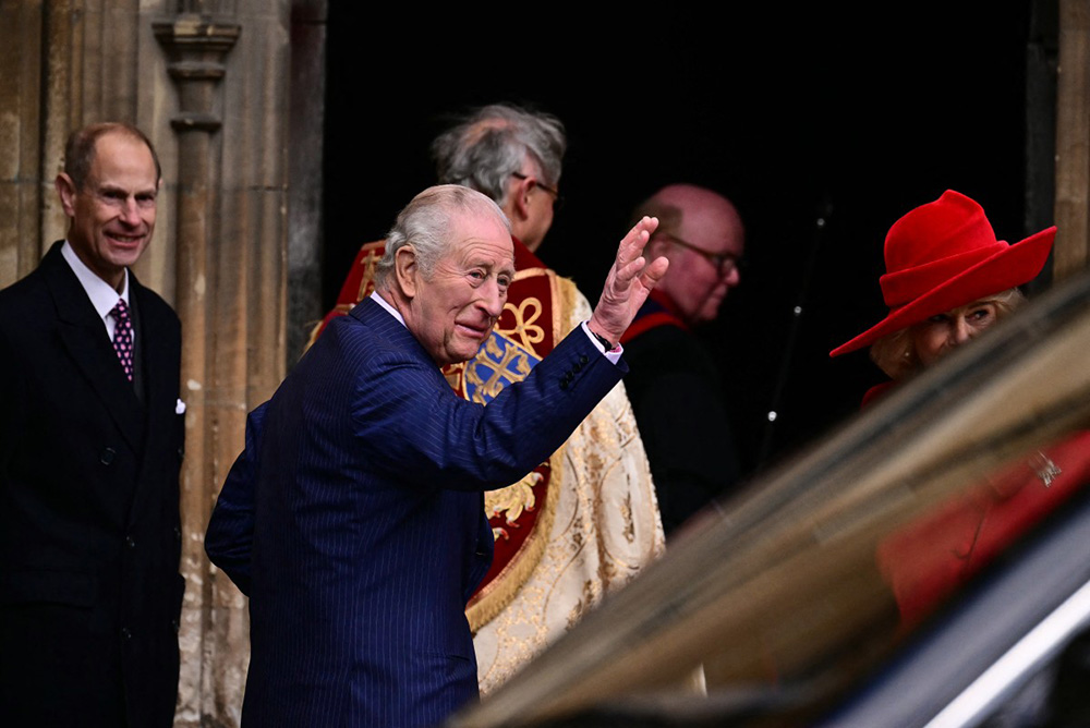 Britain's King Charles III waves as he arrives with members of his family at St George's Chapel, in Windsor, west of London, to attend the Easter Matins Service, on April 5, 2026. (Photo by Ben STANSALL / AFP)